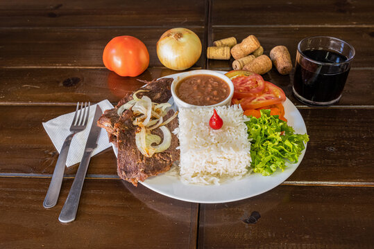 Brazilian beef dish with rice beans and vegetables