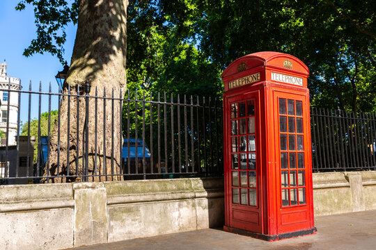 Classic Red Telephone Box on City Street in London, England, UK