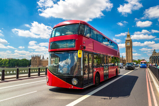 Red double decker bus on Westminster Bridge with Big Ben clock tower and Palace of Westminster in London, England, UK