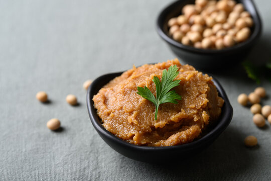 Miso paste in a black bowl. Traditional fermented soybean seasoning for Japanese cuisine