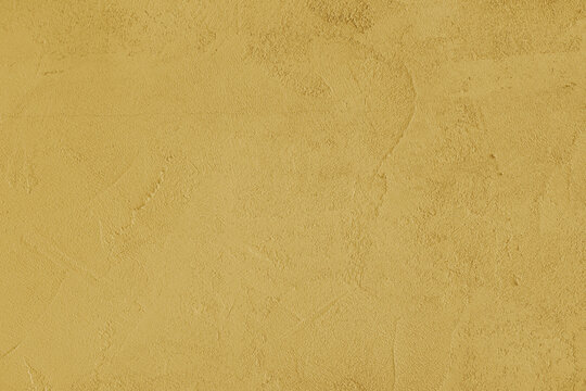 Yellow stucco wall, uneven plaster surface, painted distressed concrete texture background. Abstract grunge backdrop, wallpaper for design, construction design element