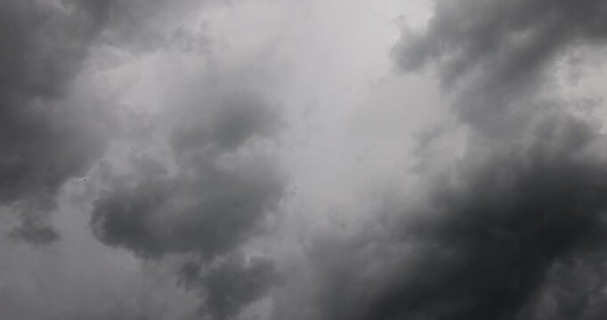 Grey storm clouds in a stormy sky, heavy dark thunderclouds and clouds cover the sun before the start of a heavy rain or summer thunderstorm, turbulence