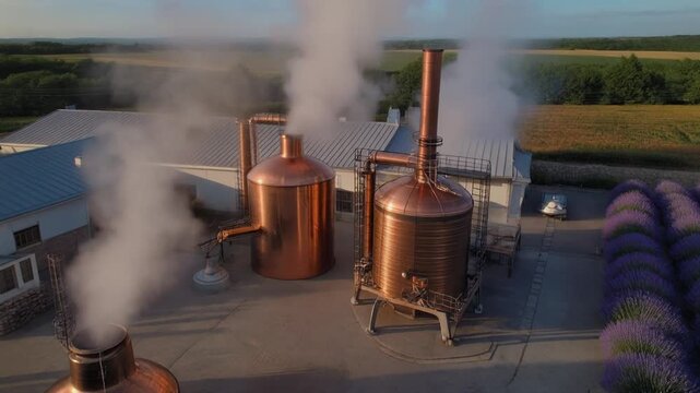 Aerial reveal of lavender distillery courtyard with steam