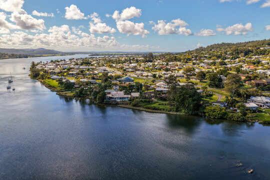Aerial view of the town of Maclean positioned along the banks of the Clarence River, showing the township, broad waterway and surrounding green rural landscape in the Northern Rivers region of NSW