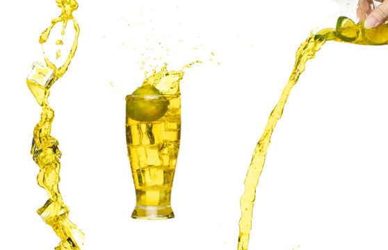 Splash spill lime juice down in ice cube glass, lime juice fall down in yellow liquid water. Green lime in juice throw splash in air. White background Isolated high speed shutter, freeze action