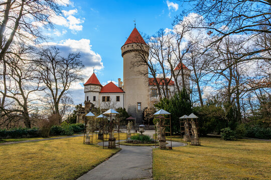 Historic european castle with red towers and a garden with sculptures. March 17, 2025, Konopiste Castle, Czech Republic