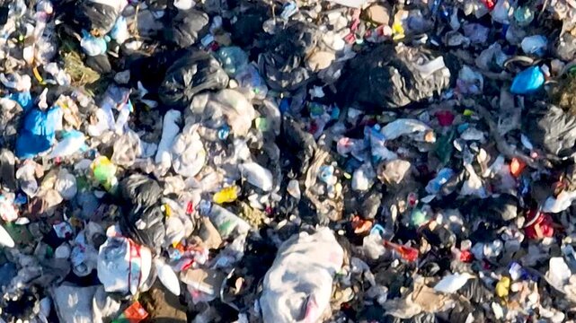 Flock of Birds Flying Over Massive Landfill with Exposed Waste and Garbage. Bigua&ccedil;u, Santa Catarina, Brazil. Aerial View.