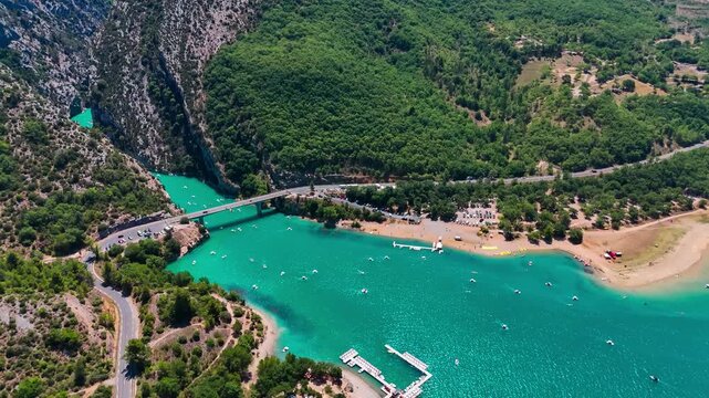 Aerial drone view of the turquoise Verdon River flowing through the Verdon Gorge river canyon in the Provence-Alpes-Cote d'Azur region of southeastern France. High quality 4k footage