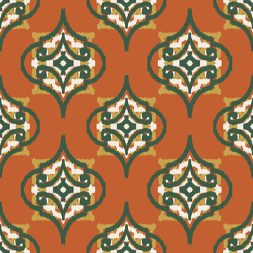 Seamless ethnic ikat pattern with terracotta orange green ogee medallion ornament. Embroidered stitch texture design for bohemian fabric, textile, apparel, wallpaper, background.