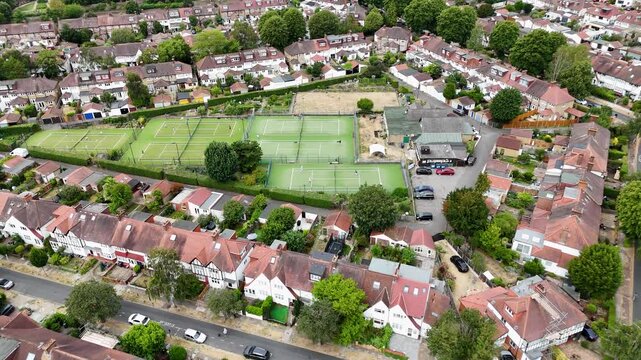 Tennis courts and a club pavilion sit in the middle of a block of Edwardian houses and rear gardens