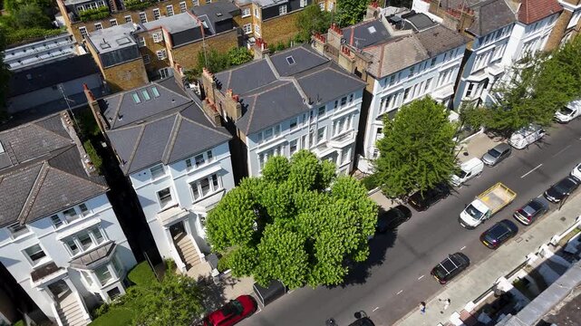 Rear elevations, glazed extensions and small private gardens of a terrace of period houses in a prime residential street