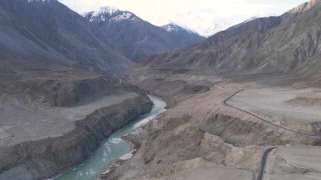 Aerial forward drone shot of the Karakoram high way old and new on both sides of the River Indus at Jaglot, Gateway to the High Peaks 