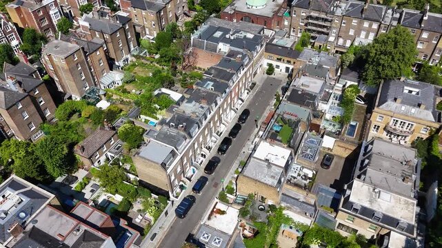 Rooftops, private gardens and a swimming pool fill the block behind a mews street in a wealthy residential district