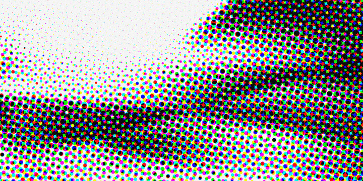 A close up view of a printed image showing distinct colorful halftone dots and patterns