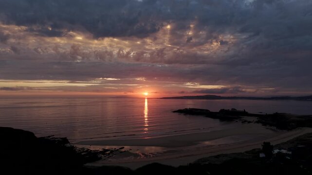 Sunset aerial view over Praia de Paxos sandy beach and calm Atlantic ocean in Galicia Spain