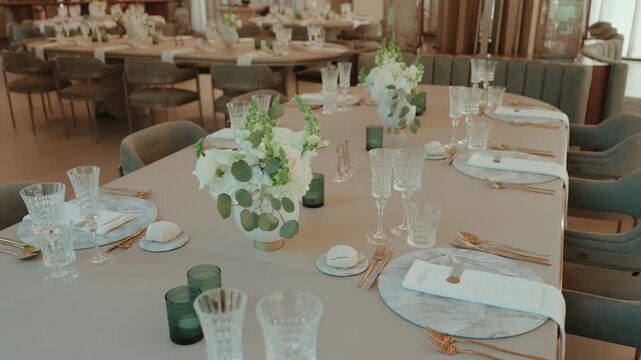 Banquet Table Set with Cut Crystal Glassware Gold Cutlery Marble Plates and White Flowers