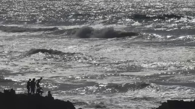 Silhouette Group People Rocky Coastline Sparkling Ocean Waves Horizontal Footage Monochrome Cinematic Casablanca Morocco Atlantic Sea Candid Coastal Video