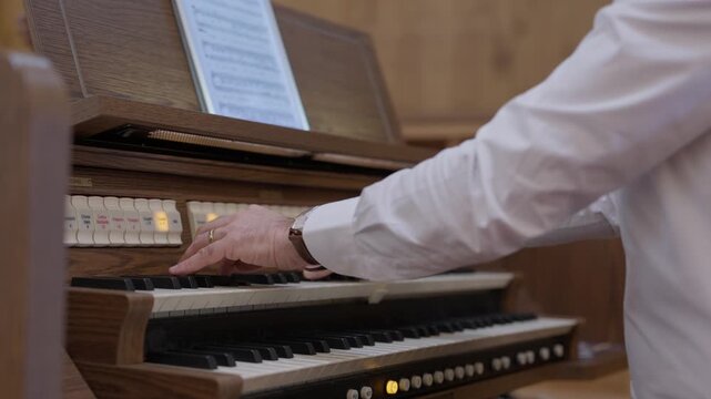 Hand In A White Shirt Adjusting The Stop Tabs Of A Two Manual Church Organ
