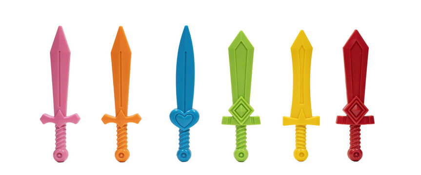Six colorful plastic toy swords in pink, orange, blue, green, yellow, and red arranged in a row isolated on a transparent background