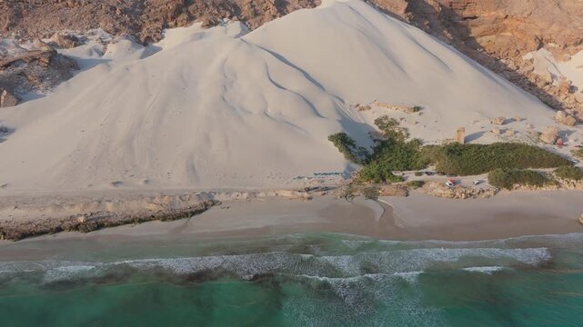 Aerial view of arher beach with large white sand dune socotra island yemen dynamic drone footage.
