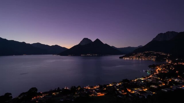 Guatemala lake atitlan at twilight with glowing city lights