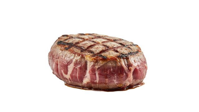 A thick cut of raw beef tenderloin steak with charred grill marks on surface isolated on a transparent background