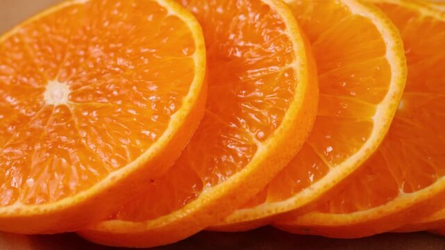 Orange fruit with slices closeup.