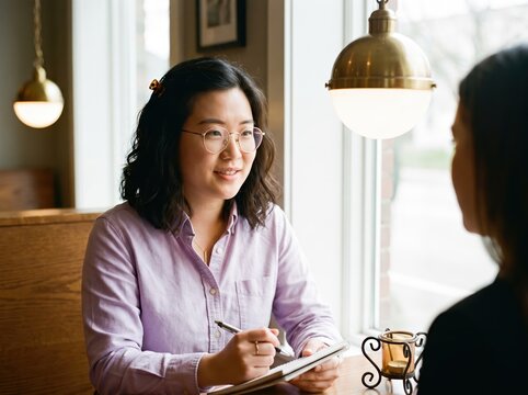 Generative AI, Asian woman interviewing or coaching over coffee at cafe