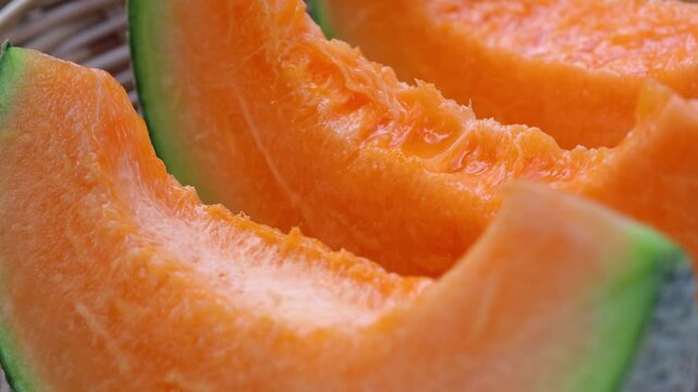 Fresh cantaloupe melon sliced on wooden