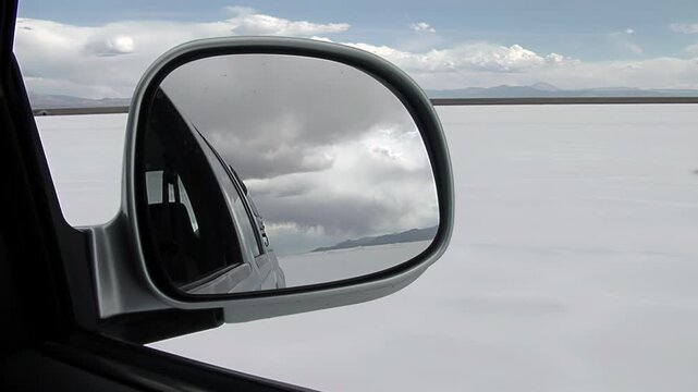 Driving Across Salt Flat In Argentina Seen Through Car Side Mirror - 4K