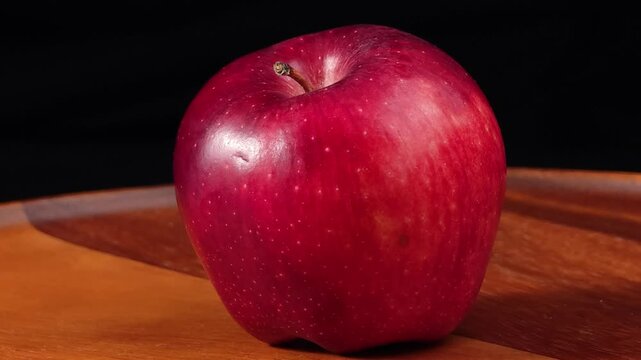 Fresh red apples on a wooden  on black background.