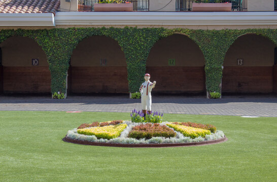 Del Mar, California USA on August 7, 2019. The statue of a jockey surrounded with a circle of colorful flowers in the paddock area at Del Mar Racetrack.