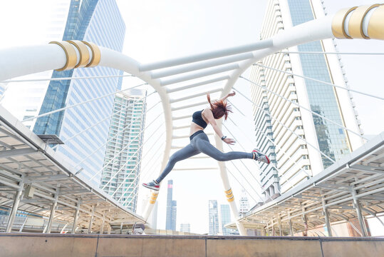 Asian young beautiful slim woman wearing sport cloths fly or jump into the sky, diet weight loss and moving for high jumping concept
