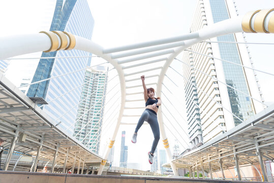 Asian young beautiful slim woman wearing sport cloths fly or jump into the sky, diet weight loss and moving for high jumping concept