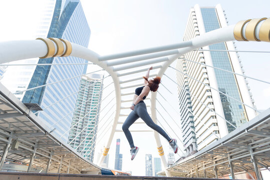 Asian young beautiful slim woman wearing sport cloths fly or jump into the sky, diet weight loss and moving for high jumping concept