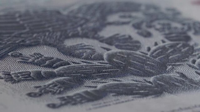 Close up of Mexican fifty peso banknote showing green denomination details, printed numbers, fine paper texture and financial design with shallow focus on currency surface