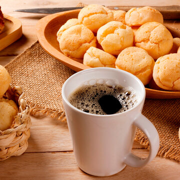 Brazilian breakfast with fresh black coffee and homemade cheese bread served in rustic baskets and platters, accompanied by corn cake.