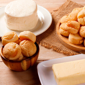 Minas Gerais cuisine featuring homemade cheese bread, fresh Minas cheese, and butter on a rustic wooden table