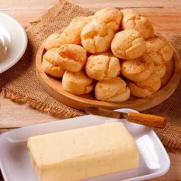 Minas Gerais cuisine featuring homemade cheese bread, fresh Minas cheese, and butter on a rustic wooden table