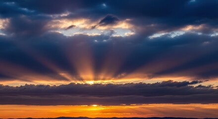 Fototapeta premium Dramatic Sunrise with Golden Light Rays Piercing Dark Clouds.