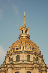 The magnificent gilded golden dome of Les Invalides against a clear blue sky in Paris, France. © iban