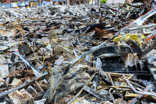 Large area filled with rubble, materials after building has been torn down there are metal scraps dirt.