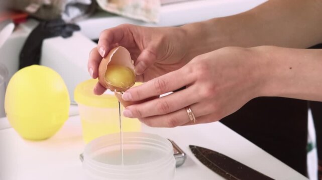 Culinary technique. Pastry recipe. Baker woman hand cracking raw egg in bowl on kitchen countertop. Cooking healthy natural dish ingredient.