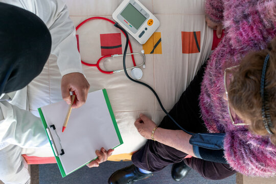 Doctor home visit with elderly patient