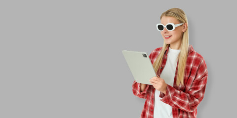 Smiling woman interacts with tablet in modern casual environment © Atlas