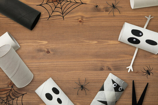 Halloween. Craft materials are laid out on wooden table for Halloween projects