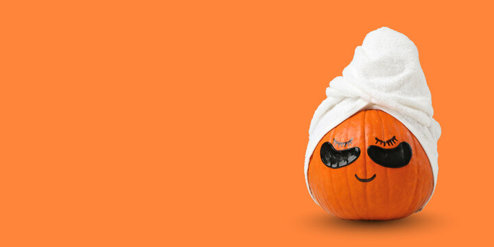 Autumn spa. Pumpkin with a towel and sunglasses promotes relaxation and fun