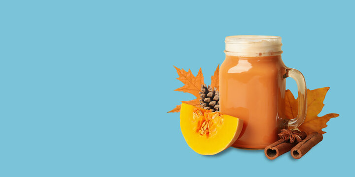 Autumn. Pumpkin spice drink served in glass jar with autumn leaves and cinnamon