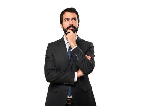 A contemplative bearded businessman in a suit looking up in deep thought