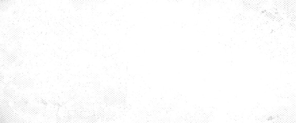 Fototapeta na wymiar Faded grey dots and halftones scattered across a stark white background